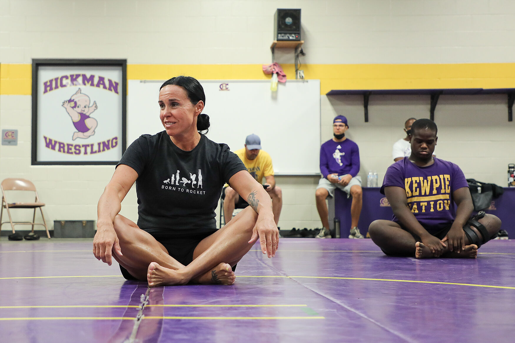Cynthia Chasteen practices sitting meditation with the Hickman high school varsity football team